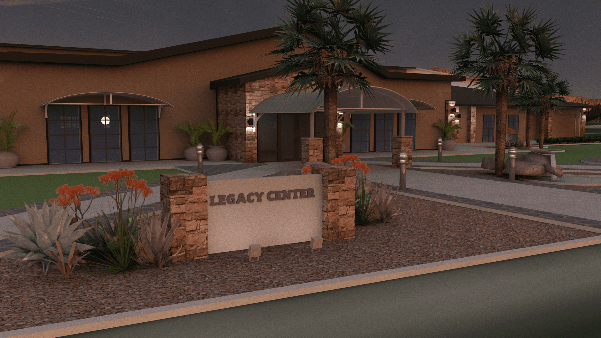 The Legacy Center stone monument sign at night with desert plantings